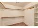 Walk-in closet with shelving, hanging racks, and carpeted floor at 7833 S Kenneth Pl, Tempe, AZ 85284