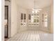 Bright dining area featuring large windows, white tile floor and a modern ceiling fan at 7833 S Kenneth Pl, Tempe, AZ 85284