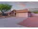 Charming single-story home with a spacious driveway and a well-manicured desert landscape at 7833 S Kenneth Pl, Tempe, AZ 85284