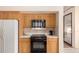 Kitchen with black oven and microwave and light wood cabinets at 7833 S Kenneth Pl, Tempe, AZ 85284