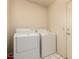 Laundry room with white tile floor and matching washer and dryer at 7833 S Kenneth Pl, Tempe, AZ 85284