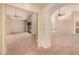 Open-concept living room with multiple ceiling fans, lots of natural light, and neutral carpet at 7833 S Kenneth Pl, Tempe, AZ 85284