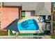 Aerial view of a private backyard oasis featuring a sparkling pool, lounge seating, and lush landscaping at 8214 E Northland Dr, Scottsdale, AZ 85251