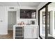 Convenient bar area with a mini-fridge, sink, and a stylish countertop at 8214 E Northland Dr, Scottsdale, AZ 85251