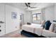 Cozy bedroom with a comfortable bed, ceiling fan, and natural light from a large window at 8214 E Northland Dr, Scottsdale, AZ 85251