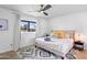 Cozy bedroom with ceiling fan, natural light, and decorative pillows at 8214 E Northland Dr, Scottsdale, AZ 85251
