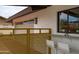 A clean exterior view showcasing a window with flower box and seating area near a detached garage at 8214 E Northland Dr, Scottsdale, AZ 85251