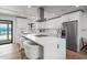 Kitchen island with seating and stainless appliances in this open concept kitchen at 8214 E Northland Dr, Scottsdale, AZ 85251