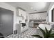 Modern laundry room with custom cabinets, quartz counters, designer tile, and ample counter space at 8214 E Northland Dr, Scottsdale, AZ 85251
