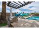 Charming outdoor kitchen with a built-in grill and bar seating next to a pool for the ultimate entertainment space at 8214 E Northland Dr, Scottsdale, AZ 85251