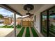 Inviting covered patio with modern fixtures, bar seating, and artificial turf accents, perfect for relaxation at 8214 E Northland Dr, Scottsdale, AZ 85251
