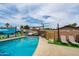 Inviting pool surrounded by comfortable seating and a playful mural for ultimate backyard relaxation and enjoyment at 8214 E Northland Dr, Scottsdale, AZ 85251