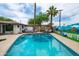 Inviting swimming pool featuring palm trees, a colorful mural, and comfortable outdoor seating for relaxation at 8214 E Northland Dr, Scottsdale, AZ 85251