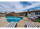 Charming swimming pool with lounge chairs, patio furniture, and lush greenery for ultimate relaxation at 8214 E Northland Dr, Scottsdale, AZ 85251