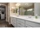 Modern bathroom with double sink vanity, white cabinets, and a large mirror at 887 W Santa Gertrudis Trl, San Tan Valley, AZ 85143