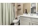 Bright bathroom with a shower/tub combination, stylish floating shelves, and a modern vanity sink at 887 W Santa Gertrudis Trl, San Tan Valley, AZ 85143