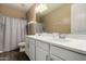 Spacious bathroom featuring a double sink vanity with white cabinets, sleek hardware, and wood-look flooring at 887 W Santa Gertrudis Trl, San Tan Valley, AZ 85143