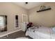 Well-lit bedroom featuring a vanity with mirror, neutral walls, and a comfortable bed at 887 W Santa Gertrudis Trl, San Tan Valley, AZ 85143