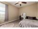 Inviting bedroom with carpet flooring, a ceiling fan, and a vanity area with a lighted makeup mirror at 887 W Santa Gertrudis Trl, San Tan Valley, AZ 85143
