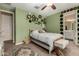 Charming bedroom with a green accent wall, ceiling fan, and a cozy aesthetic at 887 W Santa Gertrudis Trl, San Tan Valley, AZ 85143