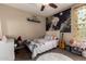 Decorated bedroom with trendy tapestry, fun pops of color, and a white upholstered bed frame at 887 W Santa Gertrudis Trl, San Tan Valley, AZ 85143