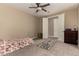 Neutral-toned bedroom with carpet flooring, a ceiling fan, and ample closet space at 887 W Santa Gertrudis Trl, San Tan Valley, AZ 85143