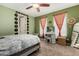 Unique bedroom with a green accent wall, ceiling fan, and a makeup vanity at 887 W Santa Gertrudis Trl, San Tan Valley, AZ 85143