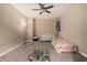 Cozy bedroom featuring neutral walls, carpet flooring, and a ceiling fan for added comfort at 887 W Santa Gertrudis Trl, San Tan Valley, AZ 85143