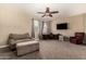 Spacious bonus room with neutral tones, features a ceiling fan, carpet, and a cozy seating area at 887 W Santa Gertrudis Trl, San Tan Valley, AZ 85143
