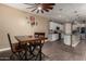 Cozy dining room with wooden table and chairs, connected to a modern kitchen at 887 W Santa Gertrudis Trl, San Tan Valley, AZ 85143