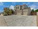 Spacious home featuring a three-car garage, a long driveway, and mature landscaping at 887 W Santa Gertrudis Trl, San Tan Valley, AZ 85143