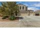 Charming home with a three-car garage, desert landscaping, and a spacious driveway at 887 W Santa Gertrudis Trl, San Tan Valley, AZ 85143