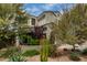 Landscaped front yard featuring desert plants, mature trees and rock ground cover at 887 W Santa Gertrudis Trl, San Tan Valley, AZ 85143