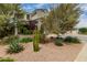 Landscaped front yard with desert plants, rock ground cover and mature trees near home at 887 W Santa Gertrudis Trl, San Tan Valley, AZ 85143