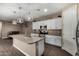 Modern kitchen with granite countertops, stainless steel appliances, and stylish pendant lighting at 887 W Santa Gertrudis Trl, San Tan Valley, AZ 85143