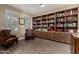 Cozy living room with hardwood floors, built-in bookshelves, and comfortable seating at 887 W Santa Gertrudis Trl, San Tan Valley, AZ 85143