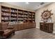 Cozy living room with hardwood floors, built-in bookshelves, and comfortable seating at 887 W Santa Gertrudis Trl, San Tan Valley, AZ 85143