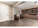 Cozy living room with hardwood floors, built-in bookshelves, and comfortable seating at 887 W Santa Gertrudis Trl, San Tan Valley, AZ 85143