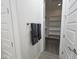 Bathroom featuring a towel rack and a door leading to walk-in closet with shelving at 9137 W Sells Dr, Phoenix, AZ 85037