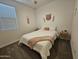 Comfortable bedroom featuring neutral decor, a ceiling fan, and cozy bedding, all bathed in natural light at 9137 W Sells Dr, Phoenix, AZ 85037