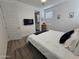 Comfortable bedroom showcasing a TV, large bed, and view of the en-suite bathroom at 9137 W Sells Dr, Phoenix, AZ 85037
