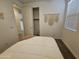 Well-lit bedroom featuring a comfortable bed, macrame wall hangings, and easy access to a closet at 9137 W Sells Dr, Phoenix, AZ 85037