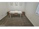 Carpeted bedroom featuring a white desk, chair, woven baskets, botanical wall art, and bright natural light at 9137 W Sells Dr, Phoenix, AZ 85037