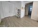 Bright entryway featuring wood-look tile flooring, white walls, and a decorative shelving unit with neutral decor at 9137 W Sells Dr, Phoenix, AZ 85037