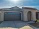 Charming single-story home with a tile roof, arched entry, and two-car garage under a bright blue sky at 9137 W Sells Dr, Phoenix, AZ 85037