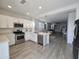 Modern kitchen with stainless steel appliances, white cabinetry, and an open layout perfect for entertaining at 9137 W Sells Dr, Phoenix, AZ 85037