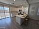 Bright kitchen with a large island, bar seating, stainless steel appliances, and ample counter space at 9137 W Sells Dr, Phoenix, AZ 85037