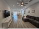 Spacious living room with modern decor, tile floors, ample seating, and an open floor plan at 9137 W Sells Dr, Phoenix, AZ 85037