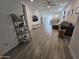 Open concept living room with sleek furniture, decorative shelving, and a relaxing atmosphere at 9137 W Sells Dr, Phoenix, AZ 85037