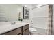 Bright bathroom featuring a single vanity, modern fixtures, and a shower-over-tub setup maximizing space and style at 9530 W Avalon Dr, Phoenix, AZ 85037